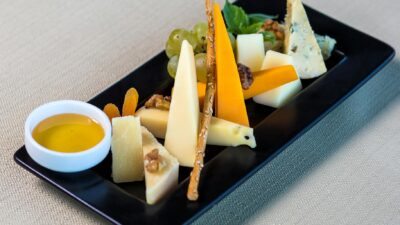 A visually appealing cheese platter featuring various cheeses, nuts, and fruits in a close-up shot.