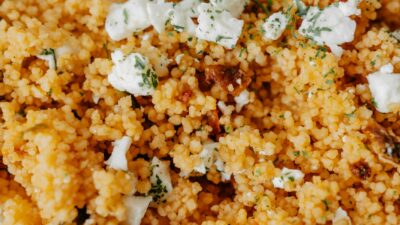 Delicious couscous salad topped with cheese and herbs. A perfect homemade dish featuring fresh ingredients.