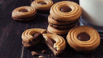 a stack of cookies next to a glass of milk