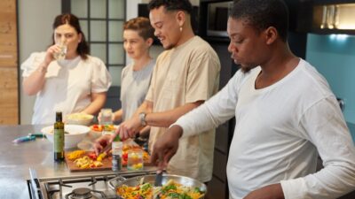 a group of people preparing food in a kitchen