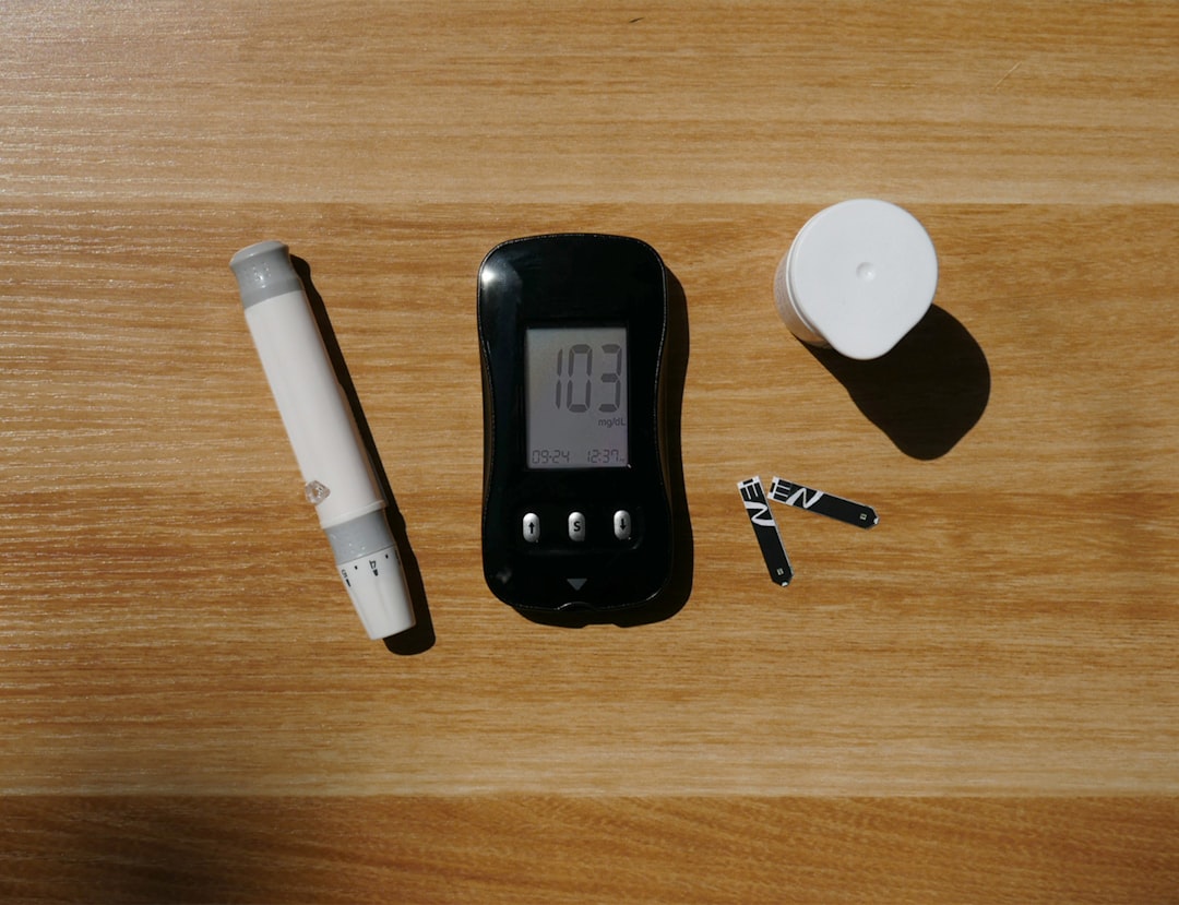 a table with a clock, a pen, and a lighter on it