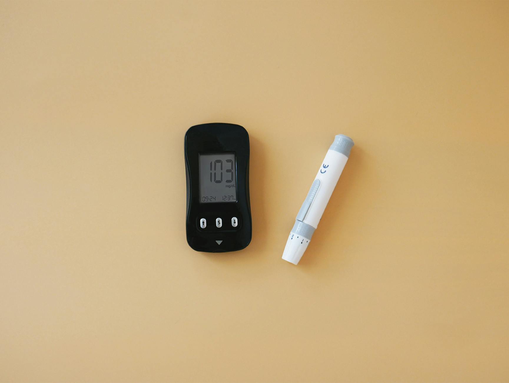 Close-up of a glucose meter and lancet pen, essential for diabetes management.