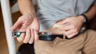 a person holding an insulin injection