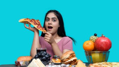 a woman eating a slice of pizza