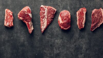 a group of raw meats laid out on a table