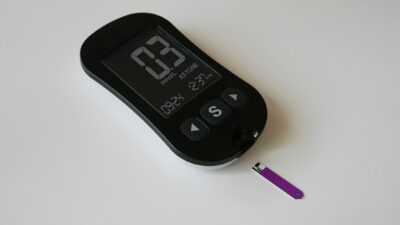 a thermometer and a purple pen on a white surface