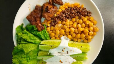 A nutritious bowl with quinoa, chickpeas, and fresh vegetables, perfect for a healthy meal.