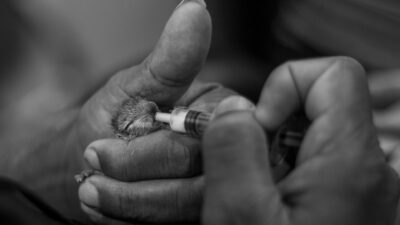 person holding a black thread