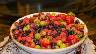 A colorful assortment of fresh berries and grapes in a bowl, highlighting nutritious fruits.