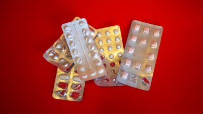 silver blister pack on red textile