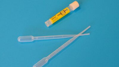 white ballpoint pen beside yellow and white plastic tool