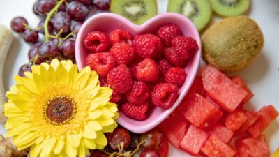 strawberries and yellow sunflower in white ceramic bowl