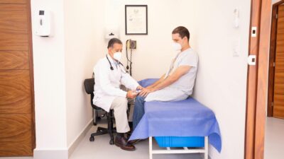 Doctor checking patient's vitals in a clinical setting for health consultation.