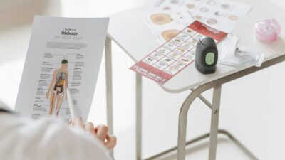 Close-up of diabetes management tools and educational materials on a table.