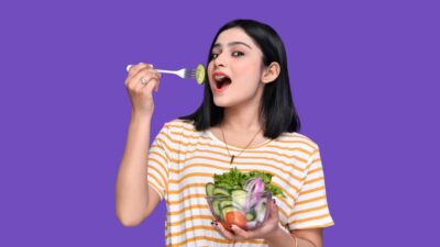 a person holding a bowl of fruit