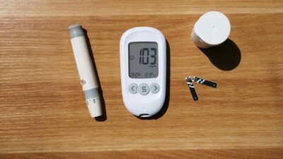 a thermometer, a pen, and a cup on a table