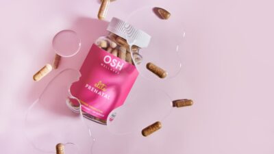 A pink box of pills and a glass of water