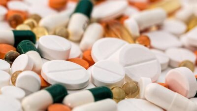 Close-up of various pills and capsules in different colors and sizes, ideal for healthcare-related content.