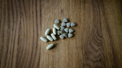 From above of set of different assorted medical pills arranged on lumber surface