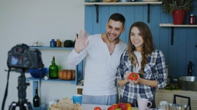 Couple filming a cooking tutorial in a kitchen
