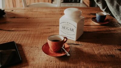 a coffee cup and a salt shaker on a table