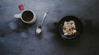 white ceramic mug and black bowl on top of table