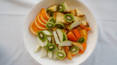 A bowl of fresh fruit salad with oranges and kiwi