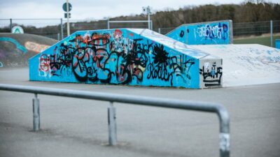 a skateboard park with graffiti on the walls
