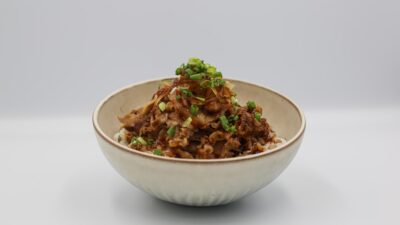 a white bowl filled with food on top of a table