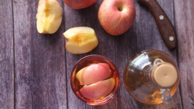 sliced apple beside black handled knife