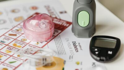 Close-up of blood sugar monitoring devices and educational materials for diabetes care.