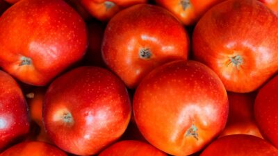 Vibrant red apples stacked together, showcasing fresh and juicy appeal.