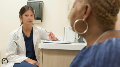 Doctor in consultation with patient at a medical clinic, discussing treatment options.