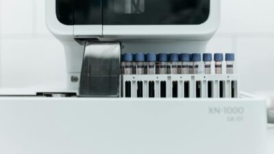 Close-up of laboratory machine holding test tubes for analysis.