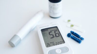a digital thermometer sitting next to a pill bottle