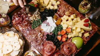 A beautifully arranged charcuterie board featuring cheeses, meats, fruits, and nuts, perfect for gatherings.