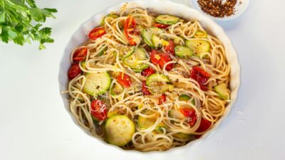 Appetizing pasta dish with zucchini and cherry tomatoes. Perfect for healthy dining.