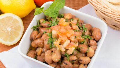 Tasty Mediterranean fava bean salad with fresh lemons, tomatoes, and herbs, perfect for a healthy meal.