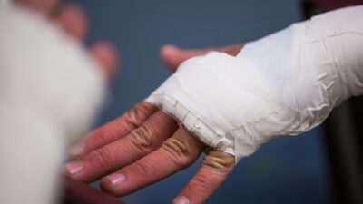 person with white bandage on hand
