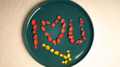 A green plate with the word love spelled out on it