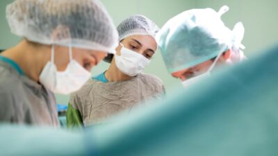 Focused medical team performing surgery in a sterile operating room environment with precision and care.