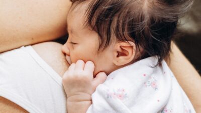 a close up of a person holding a baby