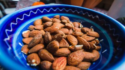 brown almond nuts on blue and white ceramic plate