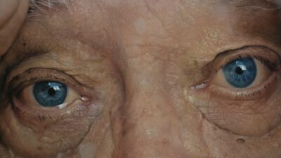 Close-up of an elderly person's blue eyes.