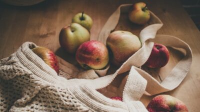 red apples on white knit textile