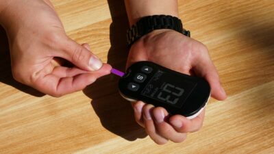 a person holding a thermometer in their hand