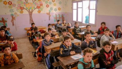 Boys attentively studying in an Idlib classroom, capturing the essence of learning and education.