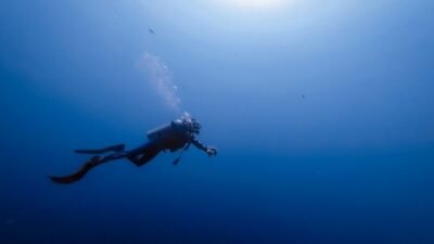 person swimming under water photography