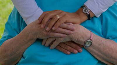person wearing silver round analog watch