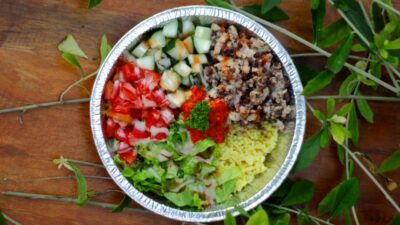 a metal bowl filled with different types of vegetables